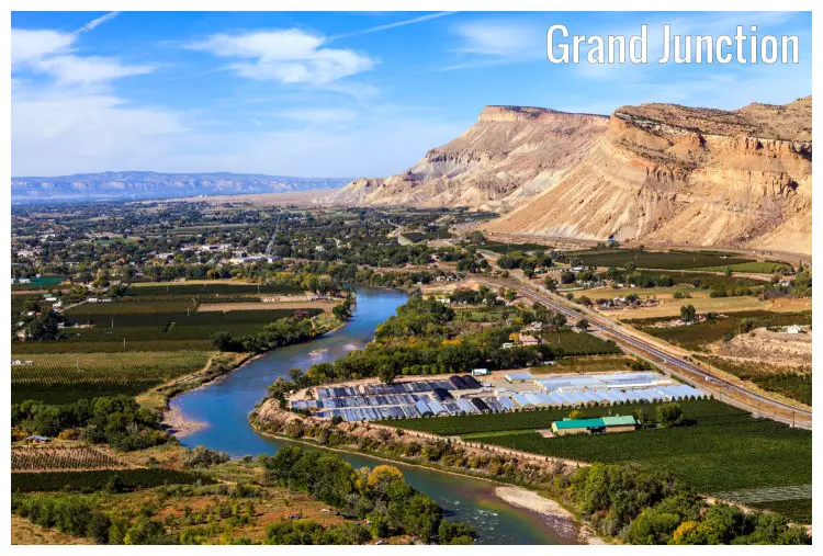 The scenic Grand Junction in Colorado with the iconic Colorado River and high hills nearby The scenic Grand Junction in Colorado with the iconic Colorado River and high hills nearby